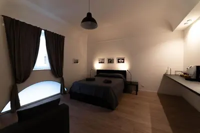 a bedroom with a bed and a large window at Monolocale Ramondetti Fileti in Palermo
