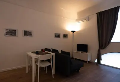 a living room with a table and a couch at Monolocale Ramondetti Fileti in Palermo