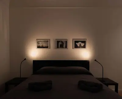 a bedroom with a bed with two lights on it at Monolocale Ramondetti Fileti in Palermo