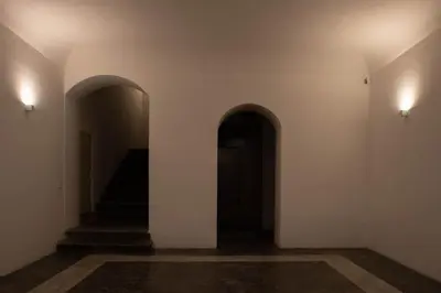 an empty hallway with two arches and a staircase at Monolocale Ramondetti Fileti in Palermo