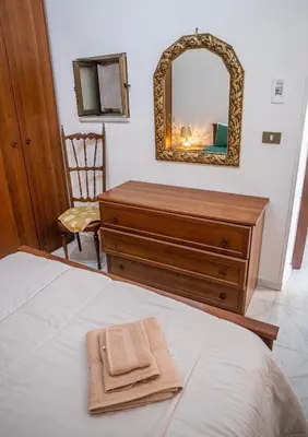 a bedroom with a dresser and a mirror at Ciuri Ciuri in Isola delle Femmine