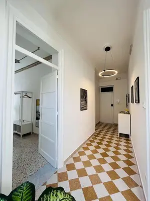 a hallway with a checkered floor in a building at Orethus Apartment - Exclusive Palermo Center in Palermo