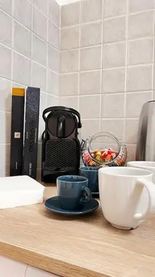 a counter with coffee cups and a toaster and a bowl of fruit at Orethus Apartment - Exclusive Palermo Center in Palermo
