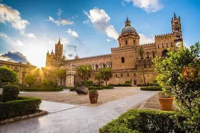 a large building with a clock tower on top of it at Orethus Apartment - Exclusive Palermo Center in Palermo