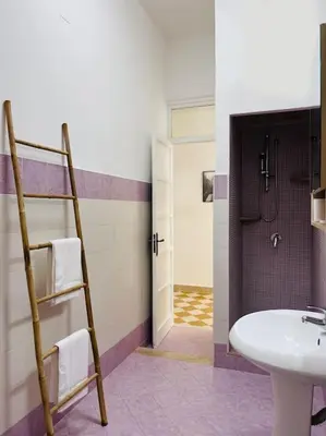 a bathroom with a sink and a ladder to a toilet at Orethus Apartment - Exclusive Palermo Center in Palermo