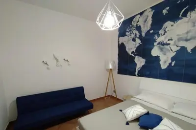 a room with a couch and a map of the world on the wall at Coral sea B2 in San Vito lo Capo