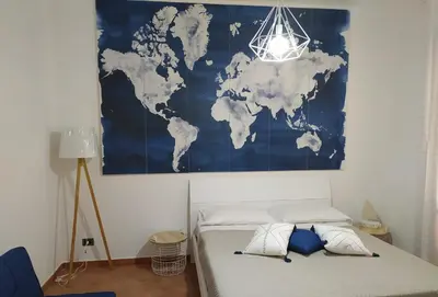 a bedroom with a map of the world on the wall at Coral sea B2 in San Vito lo Capo