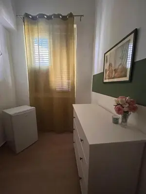 a room with a white desk and a window at GREENHOME in Palermo