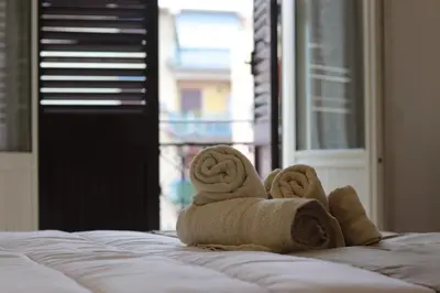 a pair of towels sitting on top of a bed at GREENHOME in Palermo