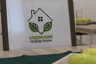 a sign for a green home holiday home at GREENHOME in Palermo