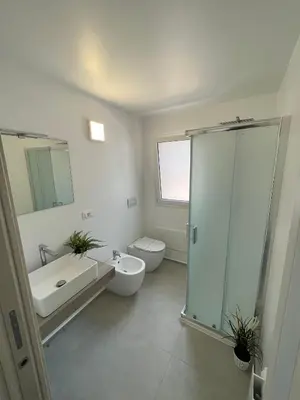 a bathroom with a shower and a toilet and a sink at La Terrazza sul Golfo in Castellammare del Golfo