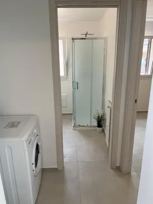 a washing machine in a room with a glass door at La Terrazza sul Golfo in Castellammare del Golfo