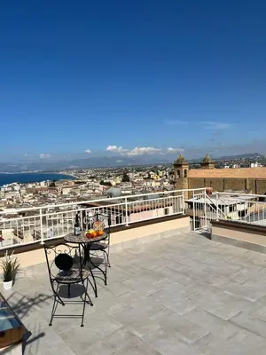 a patio with a table and chairs on a balcony at La Terrazza sul Golfo in Castellammare del Golfo