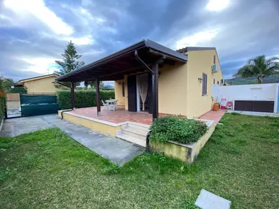 a house with a porch and a deck at Villa indipendente le coccinelle beach mare piscina a 250 mt dal mare con servizio di piscina a 400 mt 12 k da Cefalu in Campofelice di Roccella