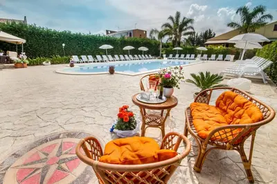 a table with food on it next to a pool at Villa indipendente le coccinelle beach mare piscina a 250 mt dal mare con servizio di piscina a 400 mt 12 k da Cefalu in Campofelice di Roccella