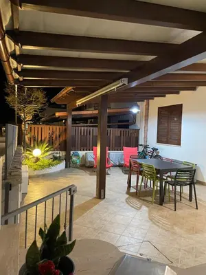 a patio with a table and chairs and a dining room at Belmare trilocale a piano terra indipendente in San Vito lo Capo