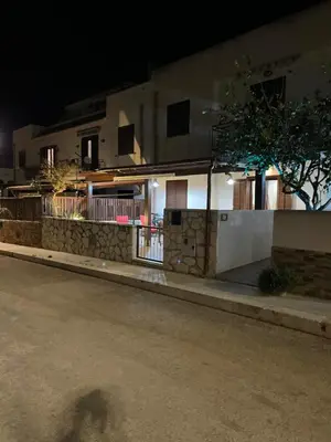 a shadow of a person on a street at night at Belmare trilocale a piano terra indipendente in San Vito lo Capo