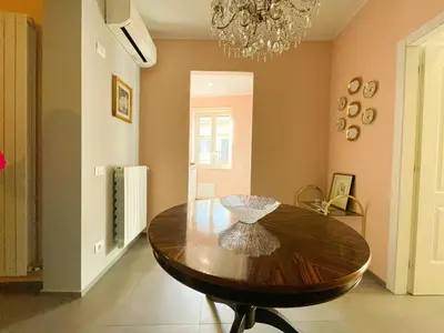 a dining room with a wooden table and a chandelier at Dimora San Gregorio Luxury Rooms in Palermo