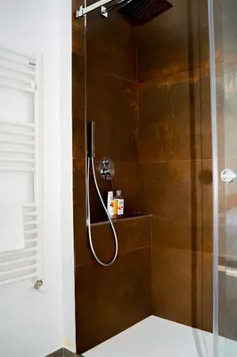 a shower with a shower head in a bathroom at Villa Giulietta in Scopello