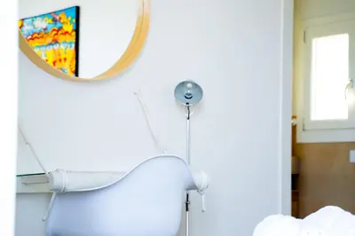 a mirror and a blow dryer on a wall at Villa Giulietta in Scopello