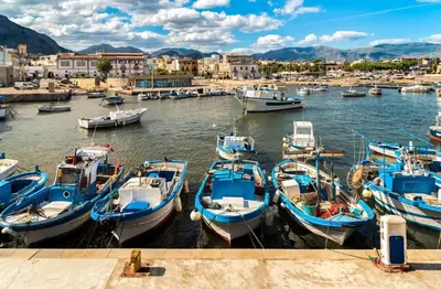 a group of boats are docked in a harbor at Casa Chiara in Isola delle Femmine