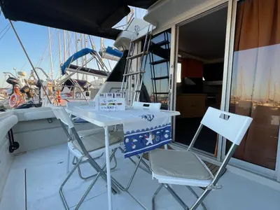 a table and two chairs on a boat at Giorgia House Boat in Palermo