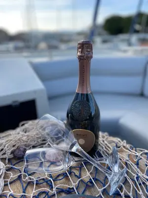 a bottle of wine sitting on a table with glasses at Giorgia House Boat in Palermo