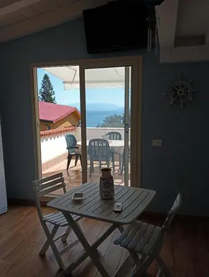 a table and chairs with a view of the ocean at Da Carmen e Peppe in Santa Flavia