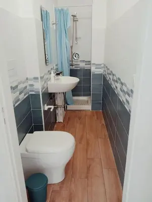 a bathroom with a toilet and a sink at Da Carmen e Peppe in Santa Flavia