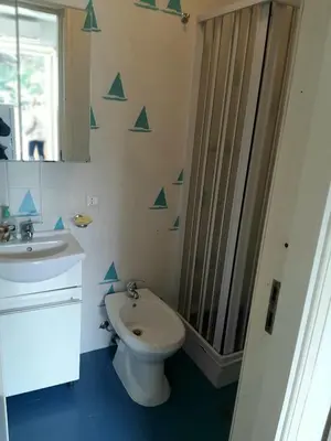 a bathroom with a toilet and a sink and a mirror at Raggio di sole in Ashur in Palermo