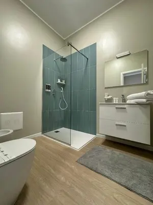 a bathroom with a shower with a toilet and a sink at Turums B&B in Castellammare del Golfo