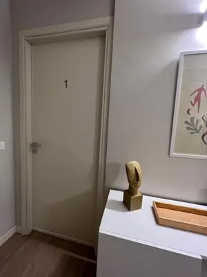 a room with a door and a statue on a table at Turums B&B in Castellammare del Golfo