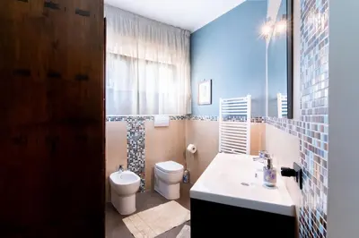 a bathroom with a white toilet and a sink at Mondello luxury villa con piscina in Mondello