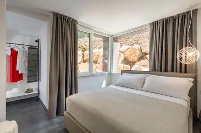a bedroom with a bed and a large window at La Dolce Vita in Castellammare del Golfo