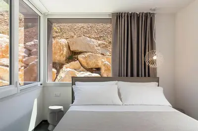a bedroom with a bed and a large window at La Dolce Vita in Castellammare del Golfo
