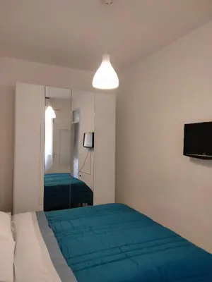 a bedroom with a bed and a mirror at Casa Vacanze L'Ortensia in Bagheria