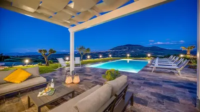 a villa with a swimming pool at night at DAMA DEI VENTI 6&2, Emma Villas in Castellammare del Golfo