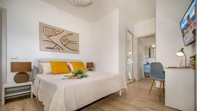 a bedroom with a bed with yellow pillows at DAMA DEI VENTI 6&2, Emma Villas in Castellammare del Golfo