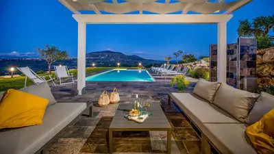 a patio with a couch and a table and a pool at DAMA DEI VENTI 6&2, Emma Villas in Castellammare del Golfo