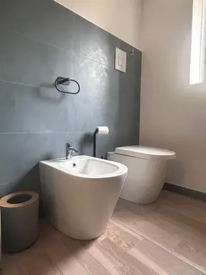 a bathroom with a tub and a toilet and a sink at villa Macari in San Vito lo Capo