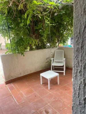 two chairs and a bench on a patio at villa Macari in San Vito lo Capo