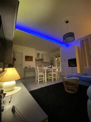 a living room with a blue light on the ceiling at Rosa Apartament in Palermo