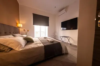 a bedroom with a large bed and a window at Sant’Agostino Boutique Rooms in Palermo