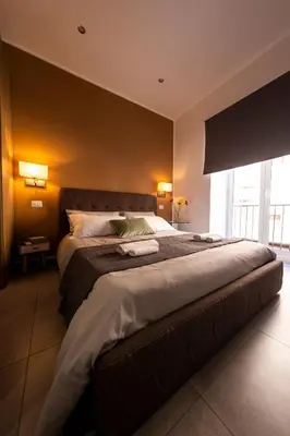 a bedroom with a large bed in a room at Sant’Agostino Boutique Rooms in Palermo