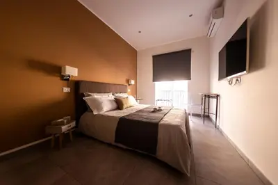 a bedroom with a large bed in a room at Sant’Agostino Boutique Rooms in Palermo