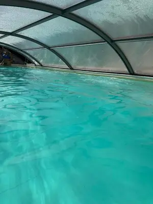a large pool of blue water with a ceiling at Villa con piscina privata riscaldata ad uso esclusivo vicino Cefalù in Lascari