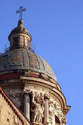 a church with a cross on top of a building at Hostel Centro Città Basement in Palermo