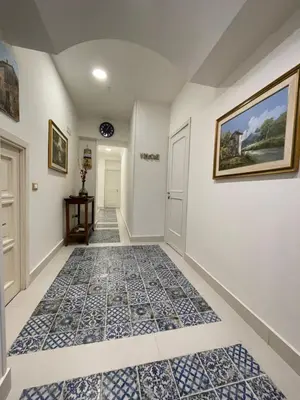 a hallway with blue and white tiles on the floor at Hostel Centro Città Basement in Palermo