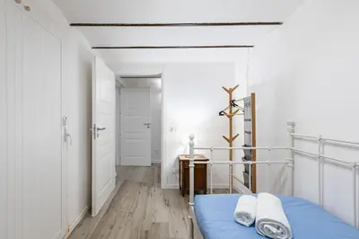 a bedroom with a blue bed and a hallway at GuestHost - Palermo Modern and Central Apartment x6 in Palermo