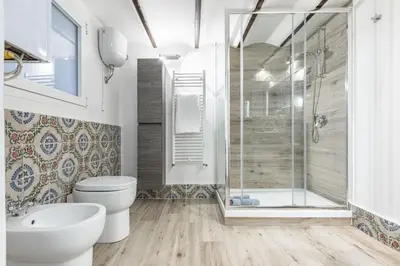 a bathroom with a shower and a toilet and a sink at GuestHost - Palermo Modern and Central Apartment x6 in Palermo